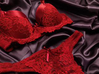 red lingerie on black silk background