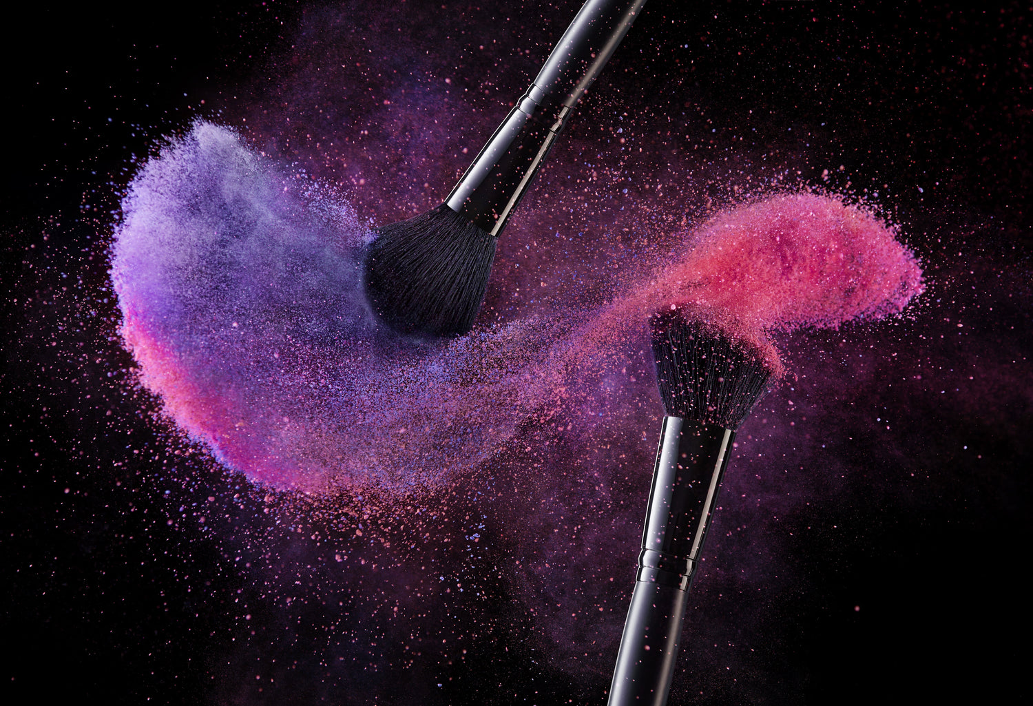 two brushes applying powder makeup